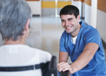 A person in a blue shirt talking to a person Description automatically generated with low confidence